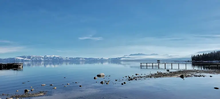 Lake Tahoe from a pier in Tahoe City with mountains in the background